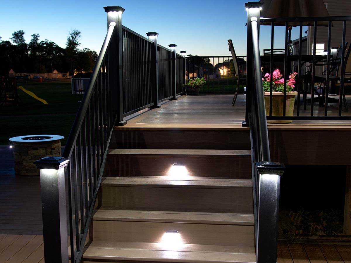Aluminum railings with lighted posts installed on a deck with a staircase in Western Pennsylvania