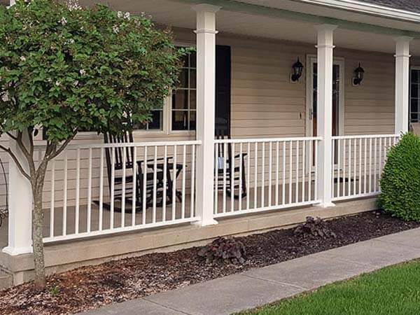 White aluminum railing installed on a front porch with columns in Western Pennsylvania