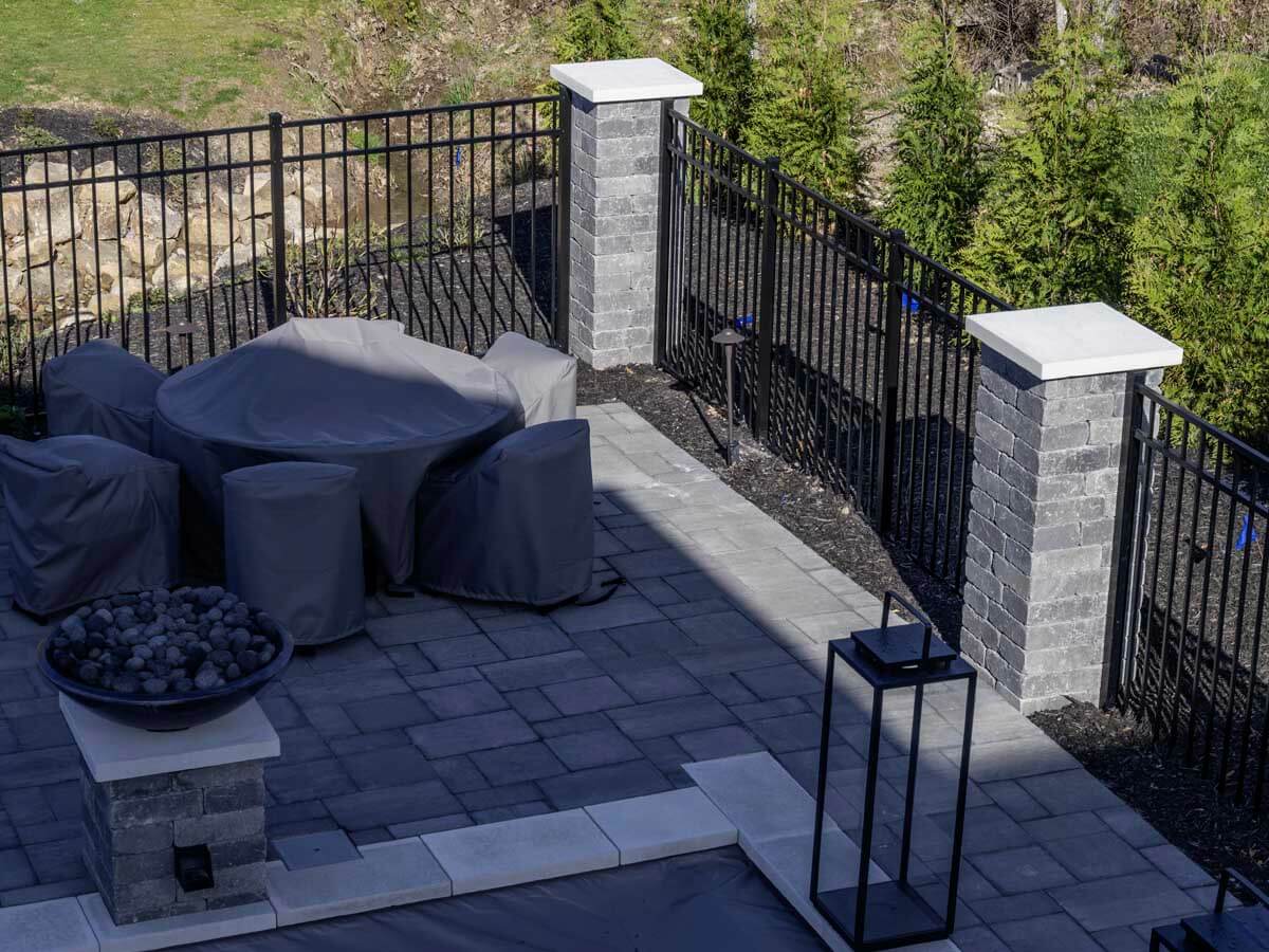 3 rail aluminum railings between brick columns installed around a porch in Western PA