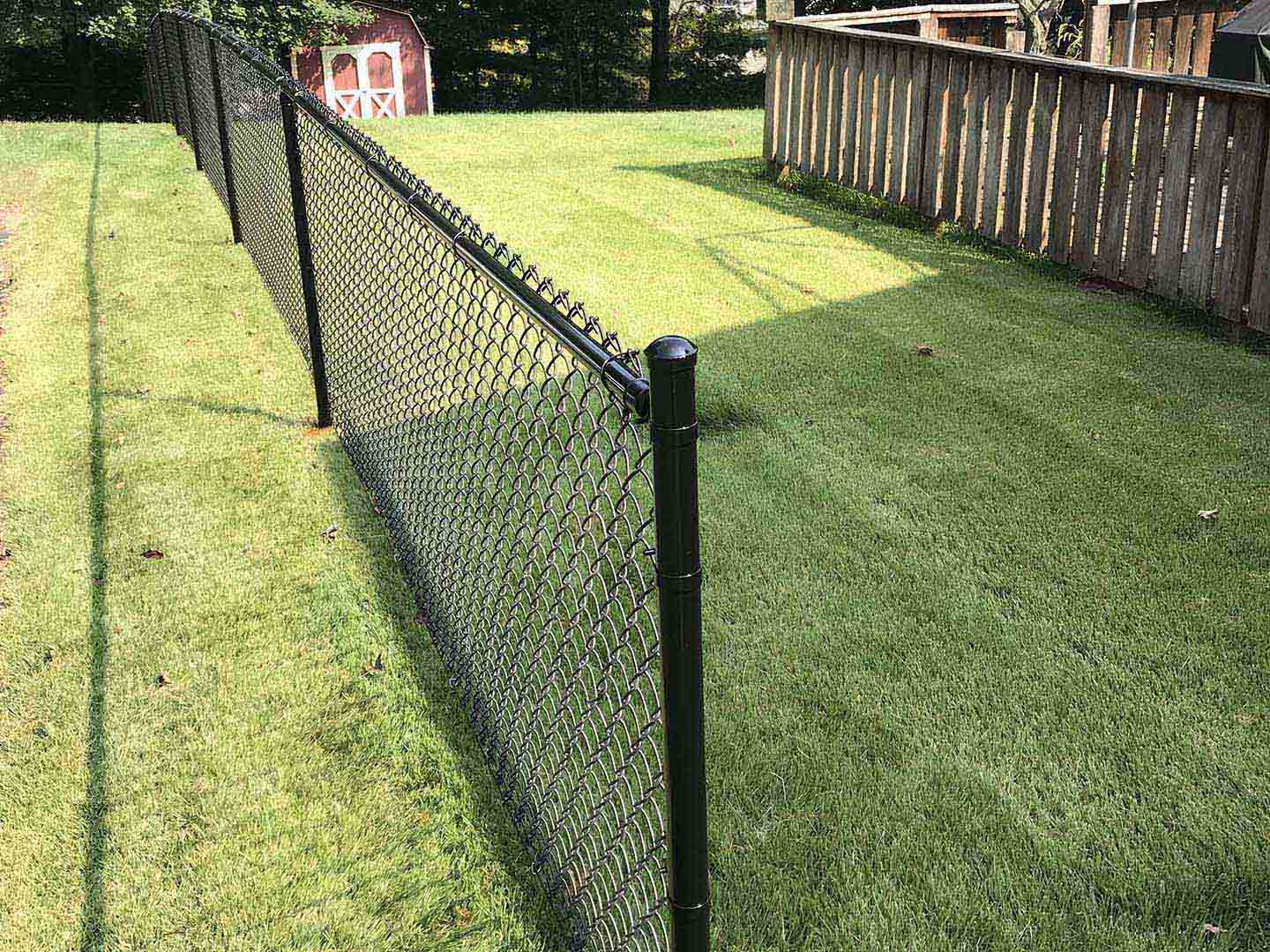 Black chain link fence installed in a back yard in Butler Pennsylvania