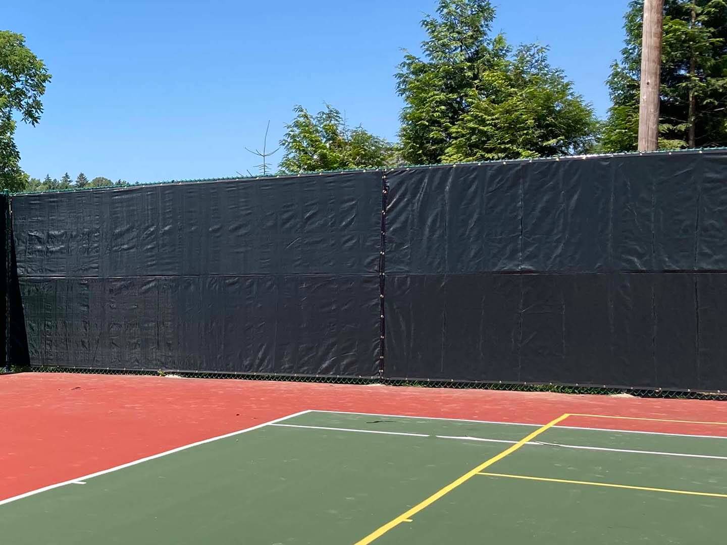 Black chain link fence with privacy screens installed at a commercial property in Butler Pennsylvani