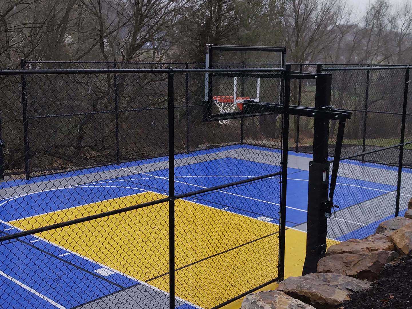 Commercial black chain link fence installed around a basketball court in Butler Pennsylvania