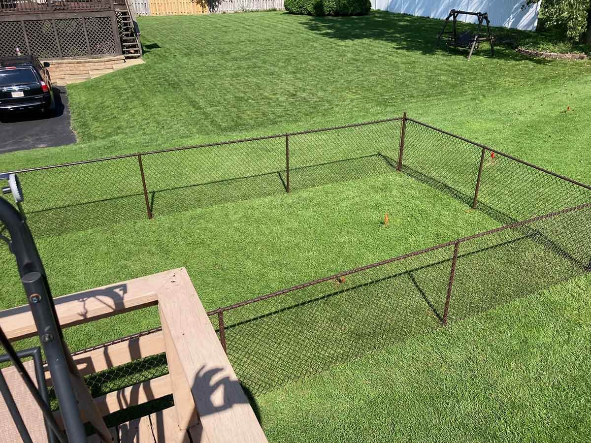 Residential Chain Link Fence Installed on Sloped Yard in Western Pennsylvania
