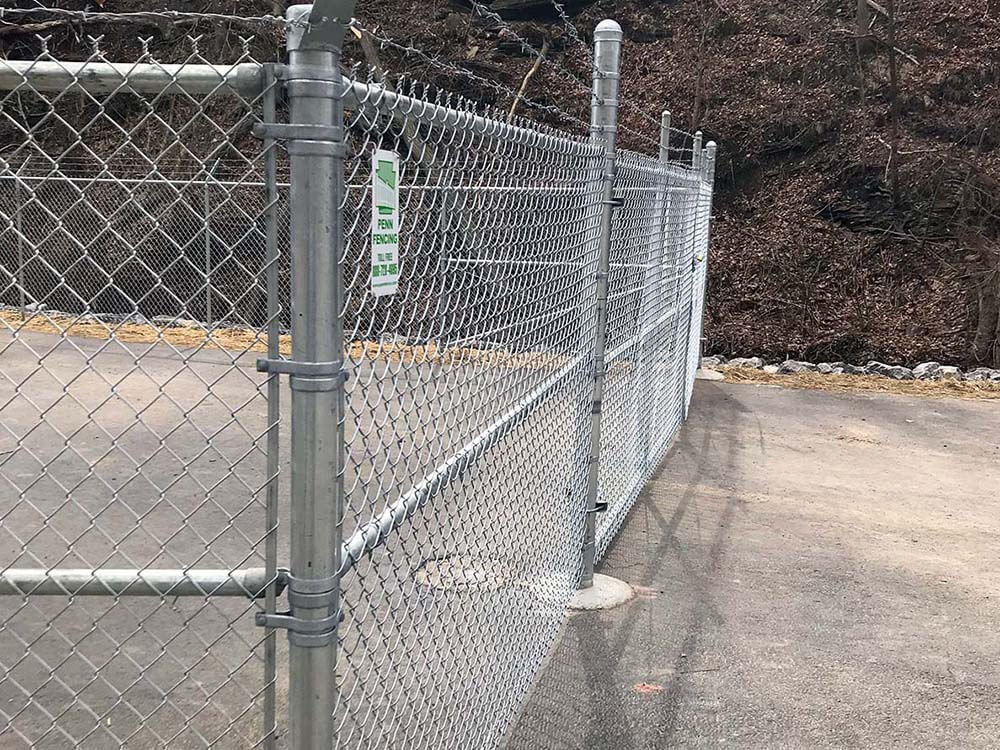 Chain link fence with barbed wire installed on a commercial property in Western Pennsylvania