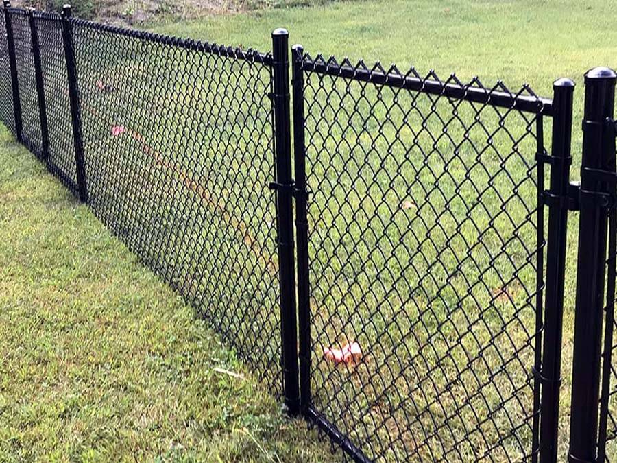 Black chain link fence with gate installed around a yard in Western Pennsylvania