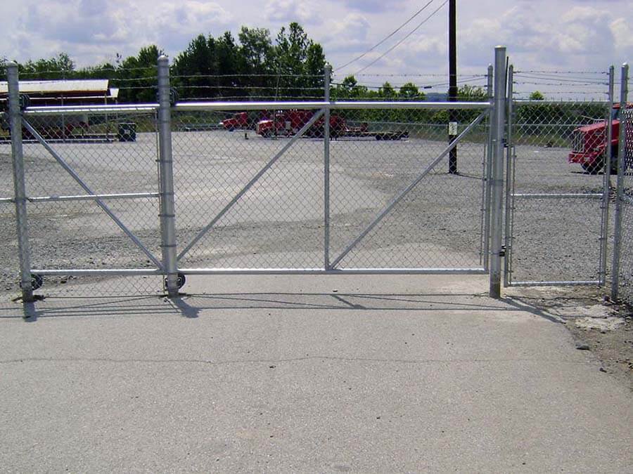 Chain link fence with barbed wire and a sliding gate installed for a commercial property in PA