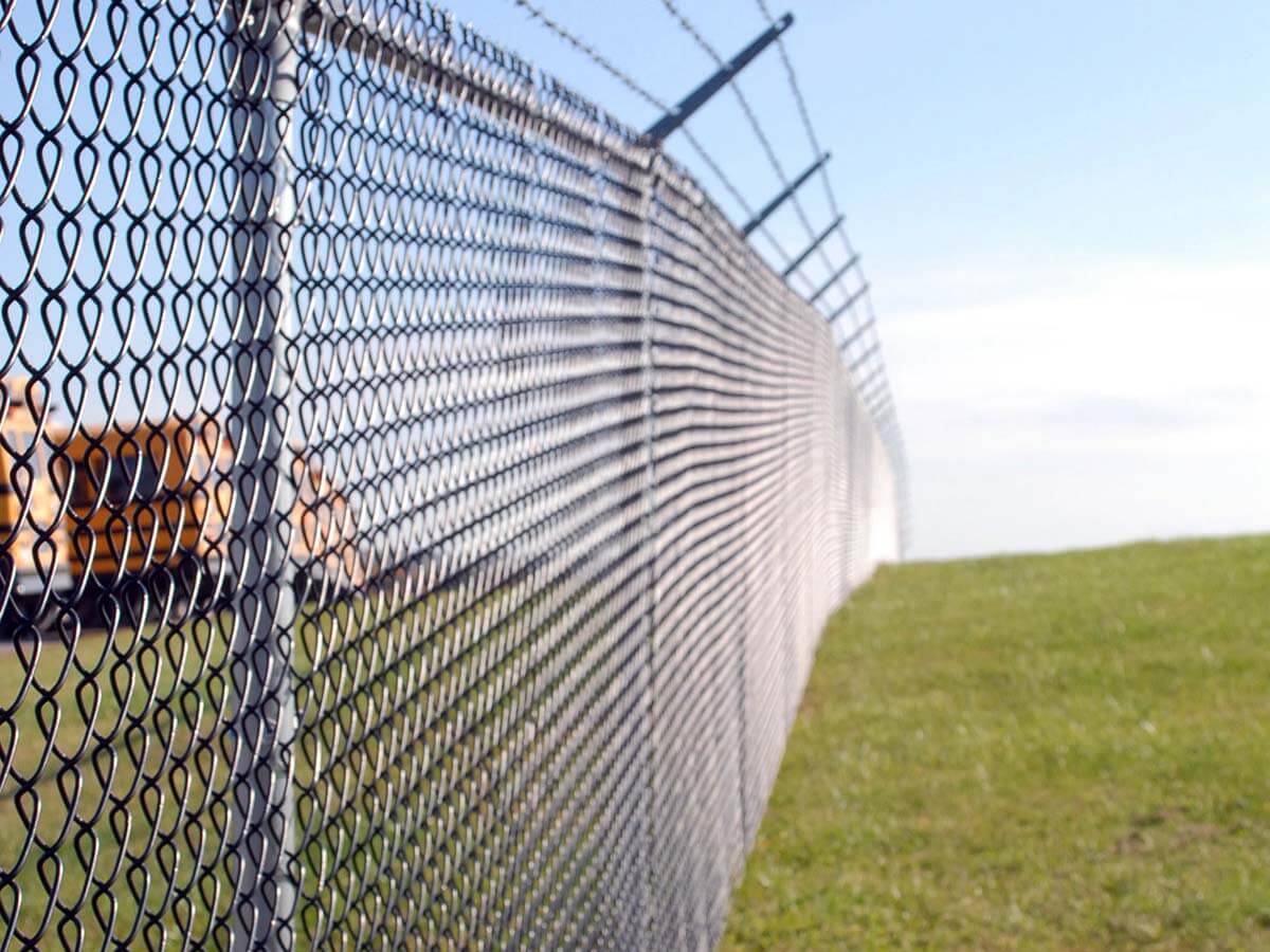 Chain link fence with barbed wire installed in Western PA on a commercial property