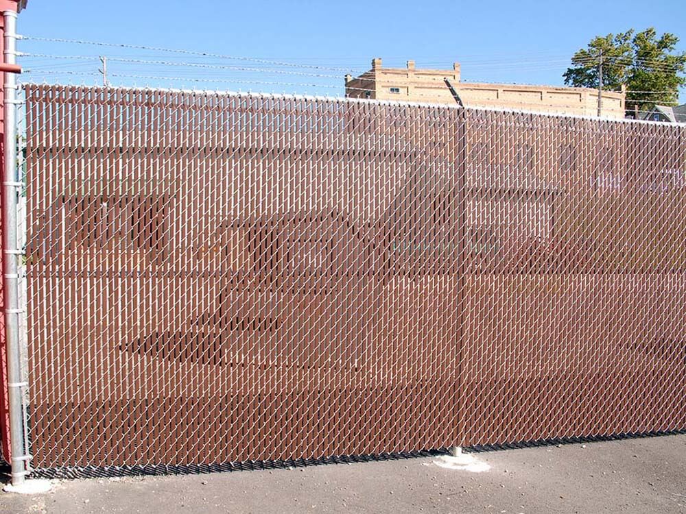 Commercial chain link fence with brown privacy slats installed in Western PA