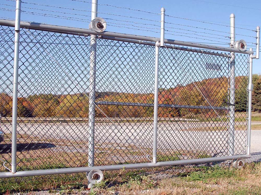 Chain link sliding gate with barbed wire on top installed for a commercial property in Western PA