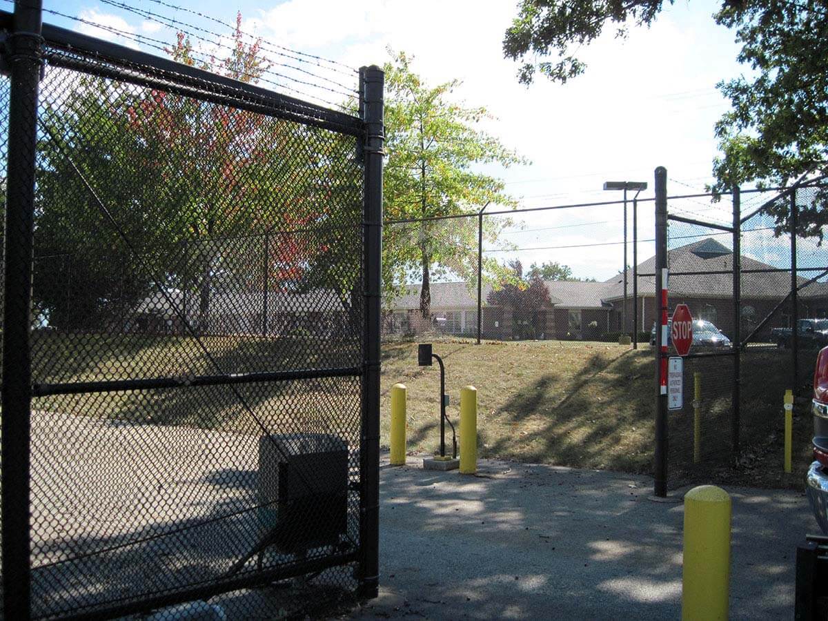 Black chain link sliding gate with access control installed in Western PA for a commercial property