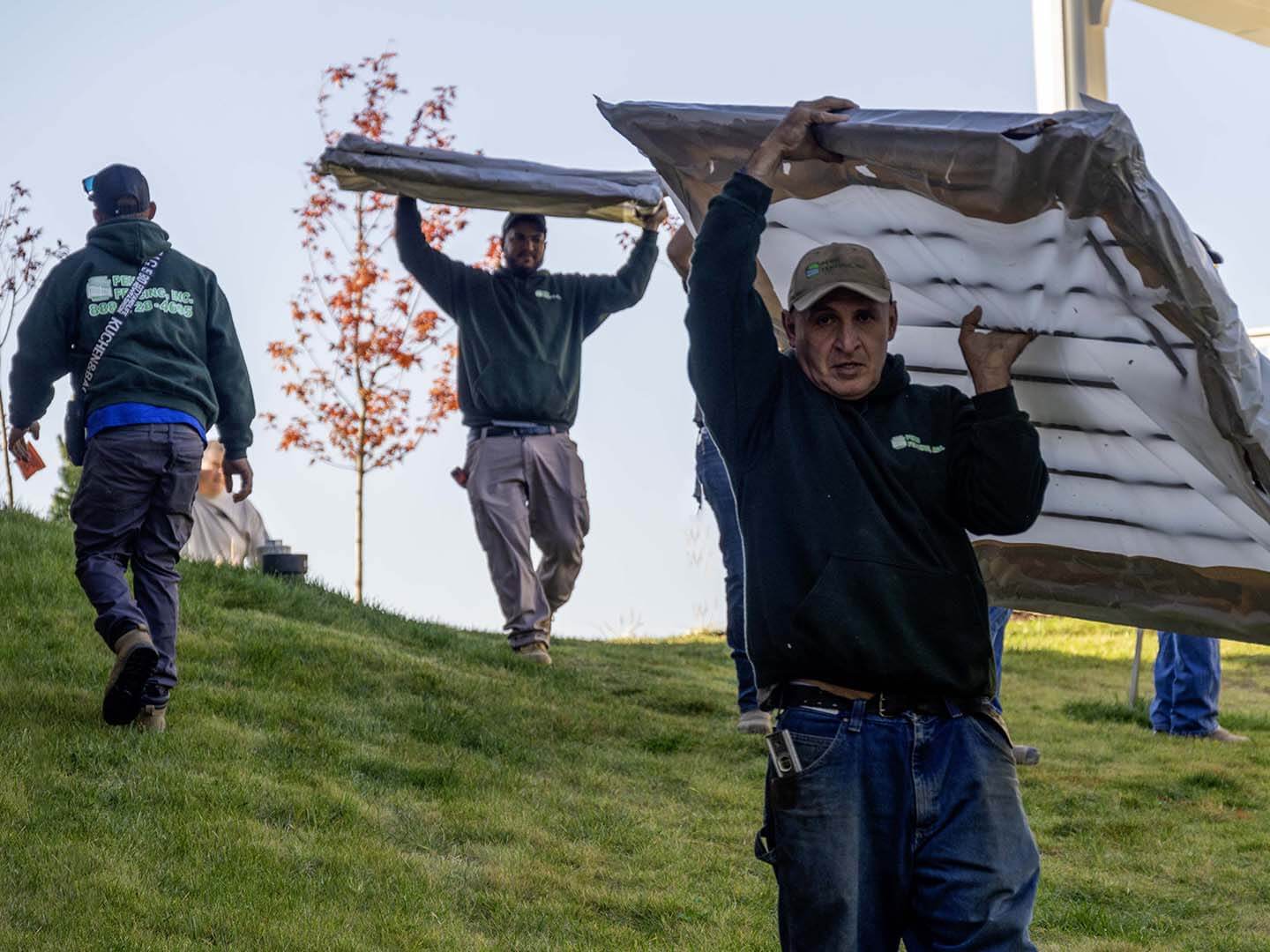 Penn Fencing employees carrying fence panels in Butler Pennsylvania 