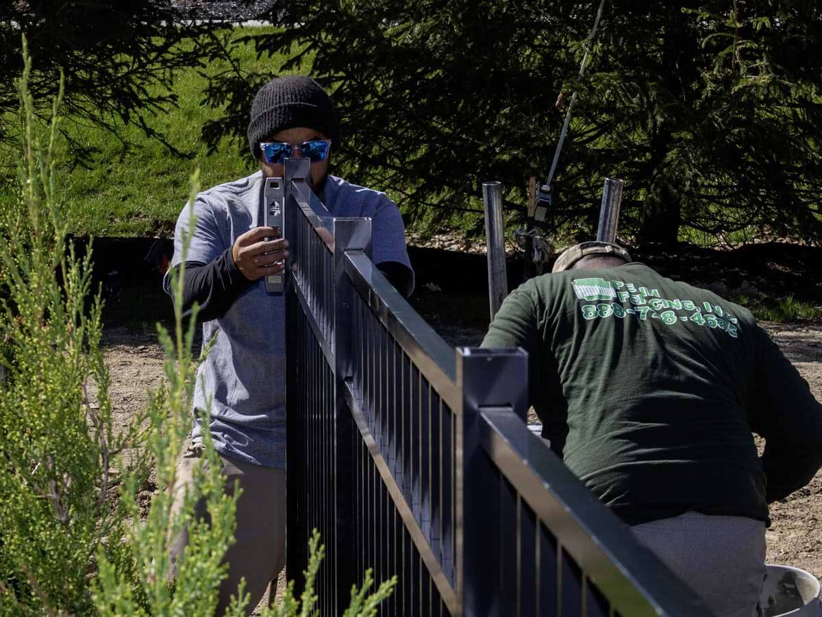 Penn Fencing in Western PA installing an aluminum fence on a residential property