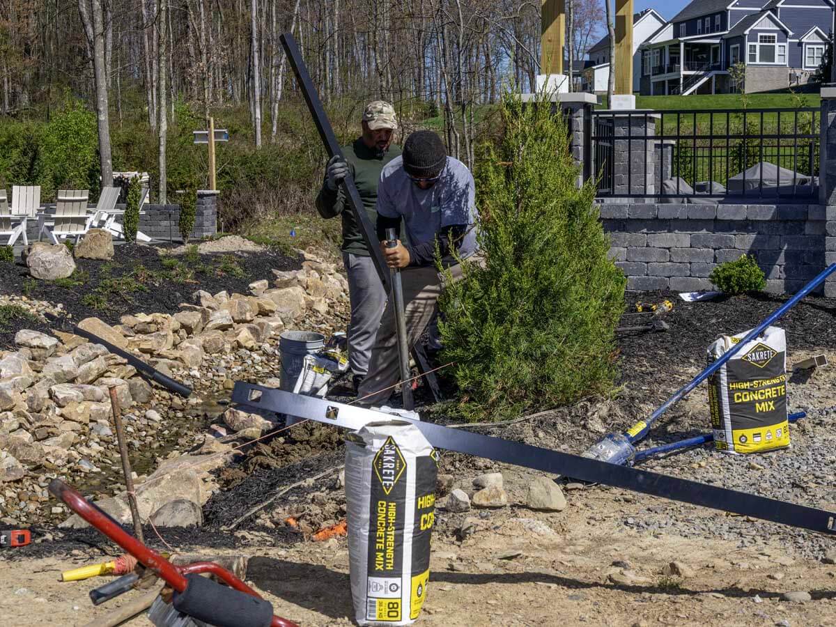 Penn Fencing workers installing an aluminum fence in Western PA