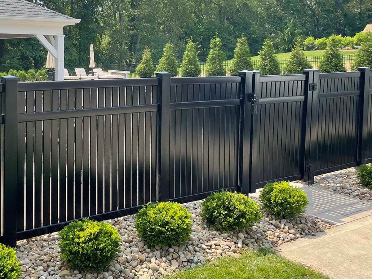 Black 3 Rail Closed Picket vinyl fence installed around a pool in Butler Pennsylvania