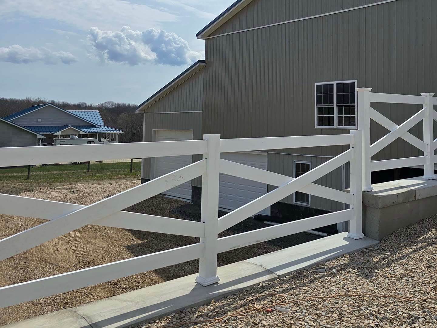 Crossbuck vinyl fence installed on a residential property in Butler Pennsylvania