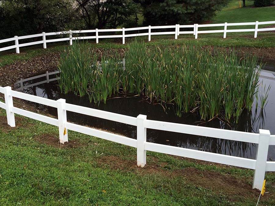 Post and board vinyl fence installed in Western Pennsylvania around a pond