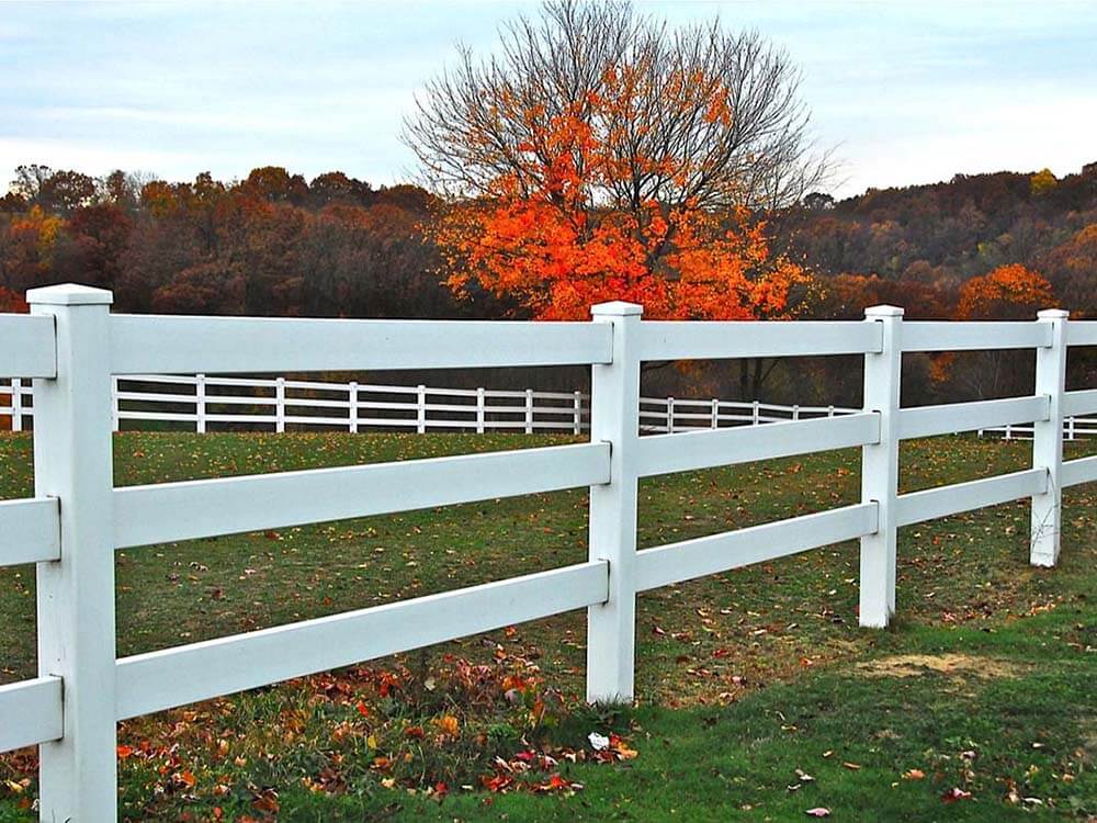 3 rail white vinyl fence installed around a field in Western Pennsylvania