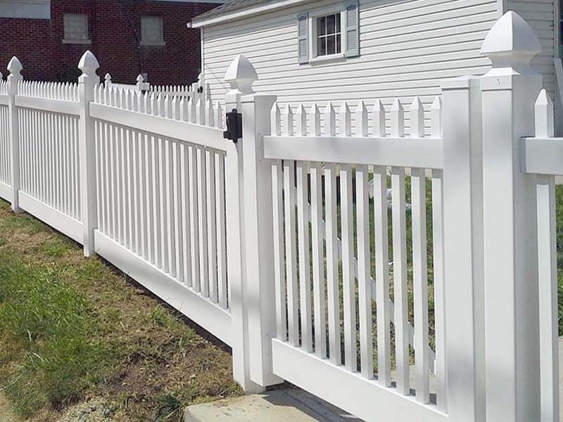 Vinyl gothic picket fence with swing gate installed in Western PA around a residential home