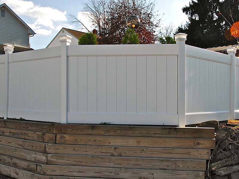 Full privacy vinyl fence with posts that have lights installed in Western Pennsylvania