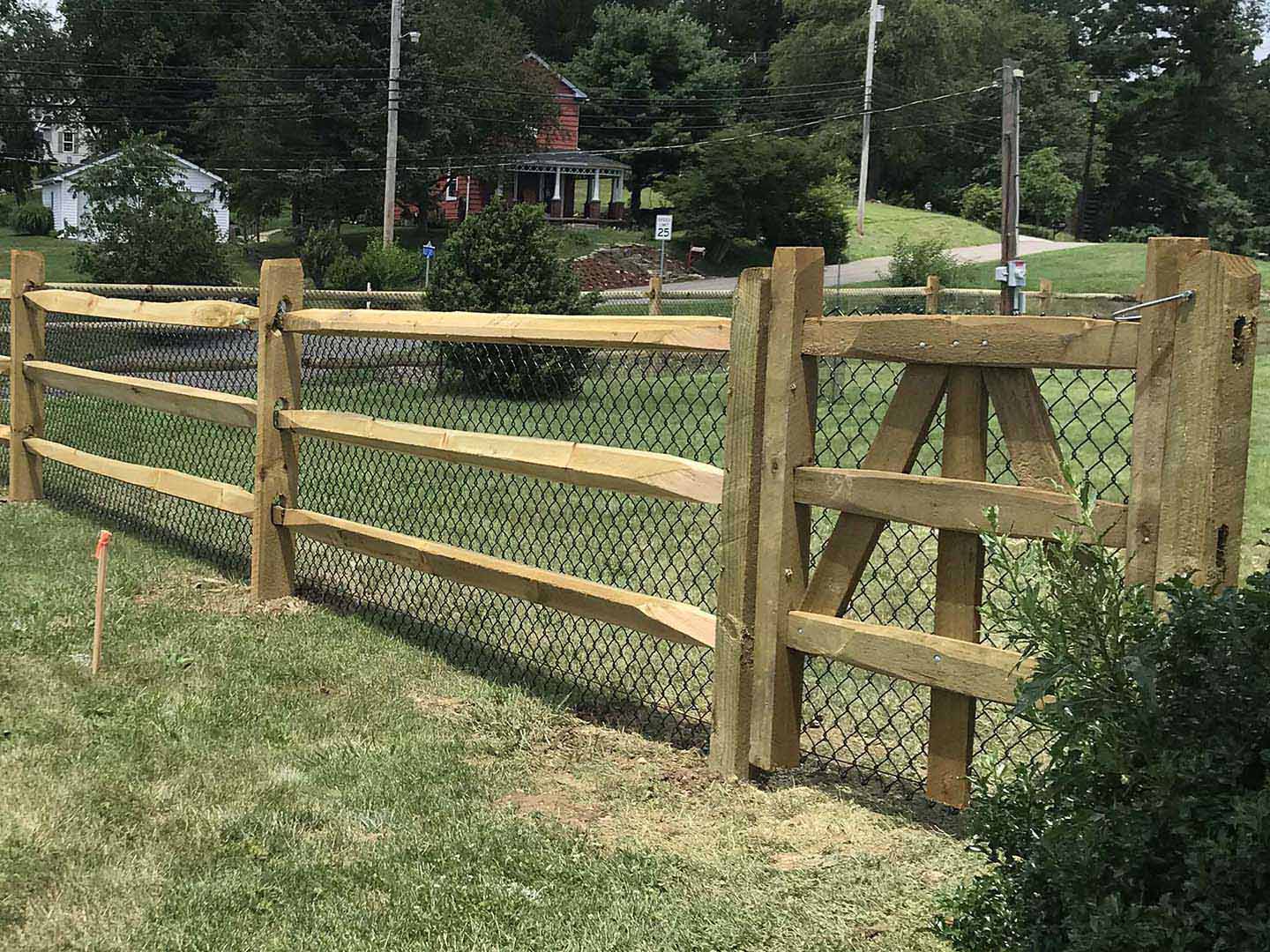 Split rail wood fence with wire mesh installed in Butler Pennsylvania on a residential property