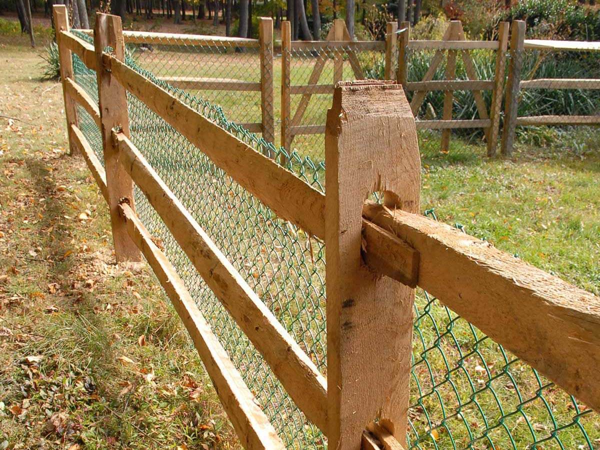 Split rail fece with green chain link installed in Western Pennsylvania